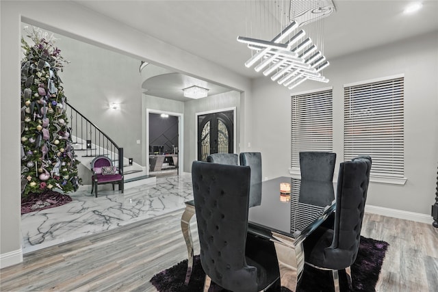 dining room with wood-type flooring and french doors