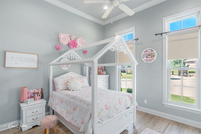 bedroom with crown molding, ceiling fan, and hardwood / wood-style floors