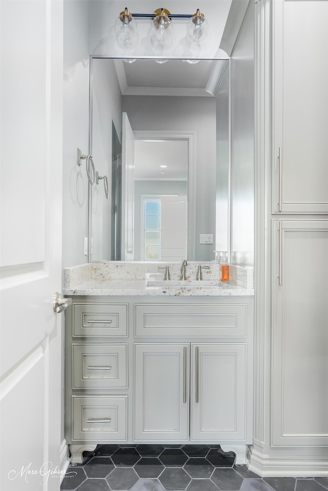 bathroom with vanity, crown molding, and tile patterned floors