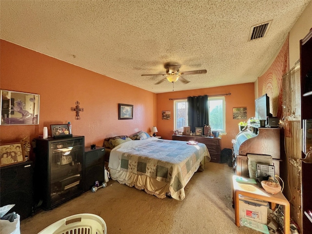 bedroom featuring ceiling fan, carpet floors, and a textured ceiling