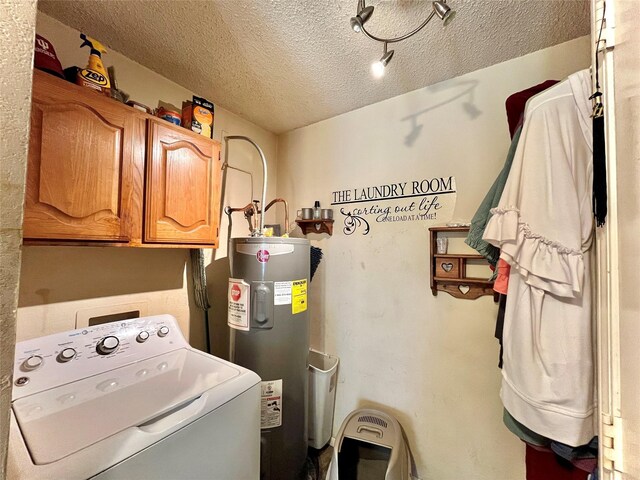 washroom featuring cabinets, washer / clothes dryer, water heater, and a textured ceiling