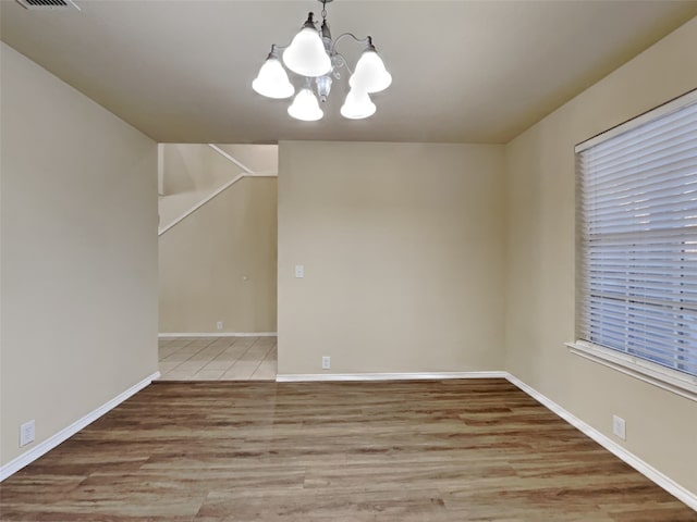 interior space with light hardwood / wood-style floors and a notable chandelier