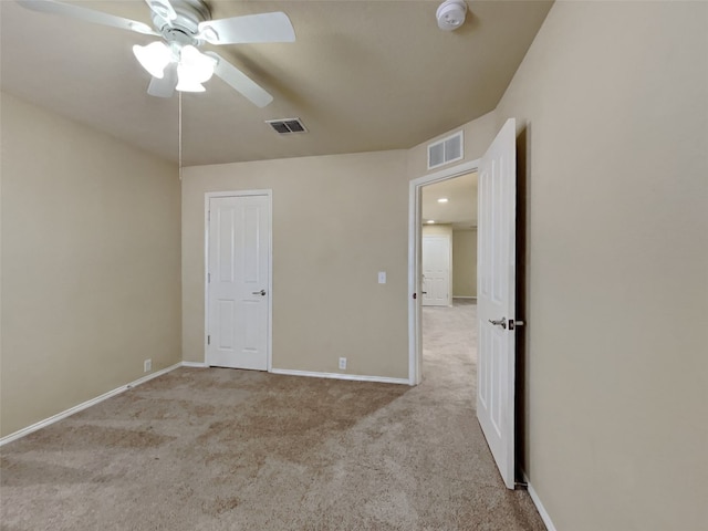 unfurnished bedroom with ceiling fan and light carpet