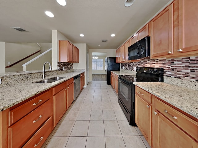 kitchen featuring sink, backsplash, black appliances, light stone countertops, and light tile patterned flooring