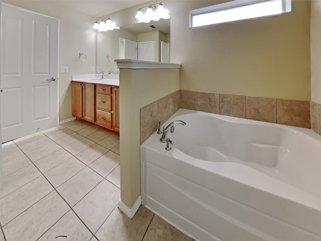 bathroom with a tub to relax in, tile patterned floors, and vanity