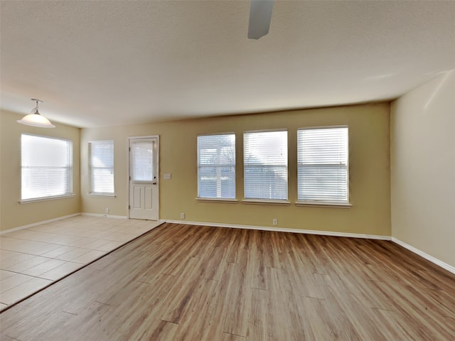 unfurnished living room featuring a healthy amount of sunlight and light hardwood / wood-style flooring