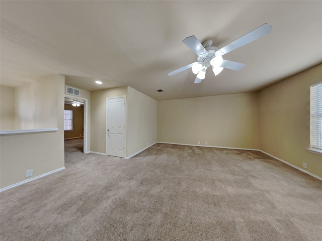 unfurnished room featuring light carpet and ceiling fan