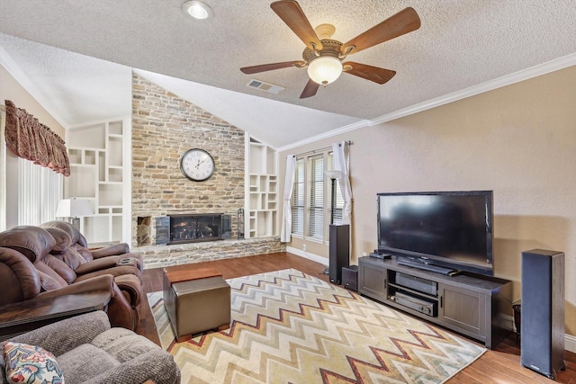 living room with vaulted ceiling, built in features, a textured ceiling, and light hardwood / wood-style flooring