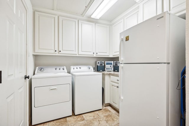 laundry room featuring washing machine and dryer and cabinets