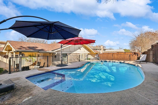 view of pool featuring a patio area and an in ground hot tub