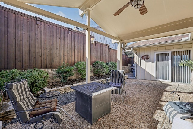 view of patio / terrace featuring ceiling fan and a fire pit