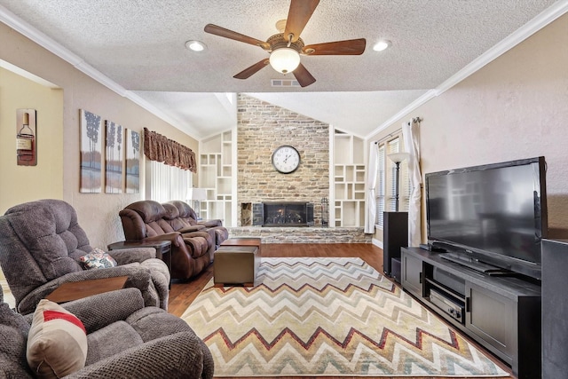 living room with lofted ceiling, crown molding, built in features, a textured ceiling, and light wood-type flooring