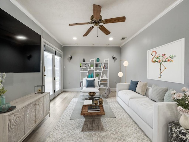 living room with crown molding, light hardwood / wood-style floors, french doors, and ceiling fan