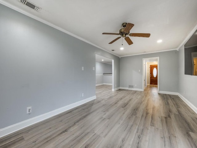 empty room with crown molding, ceiling fan, and light hardwood / wood-style flooring