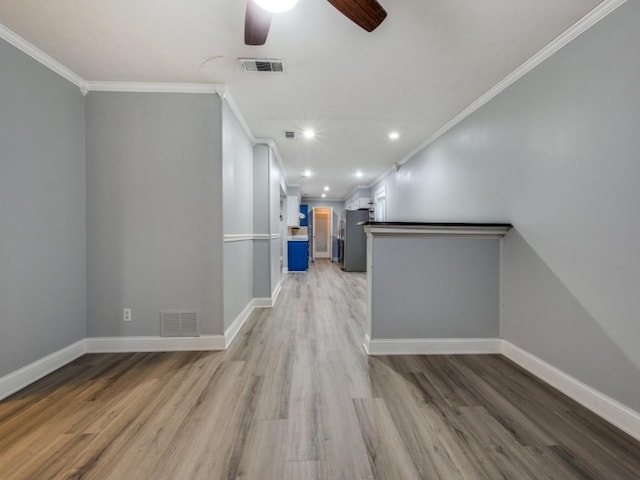 hallway with crown molding and light hardwood / wood-style flooring