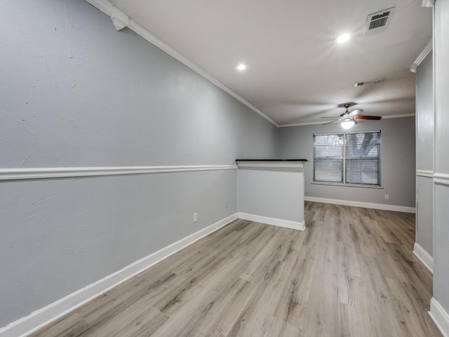 unfurnished room with ceiling fan, ornamental molding, and light hardwood / wood-style flooring