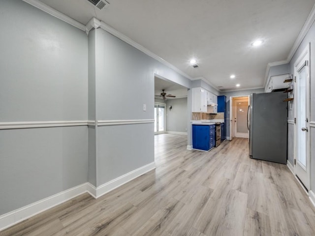 kitchen with white cabinetry, light hardwood / wood-style flooring, blue cabinets, and appliances with stainless steel finishes