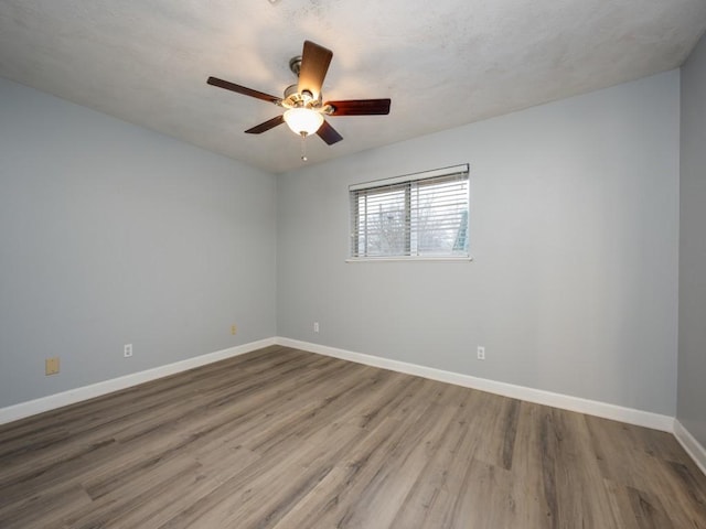 empty room featuring hardwood / wood-style flooring and ceiling fan