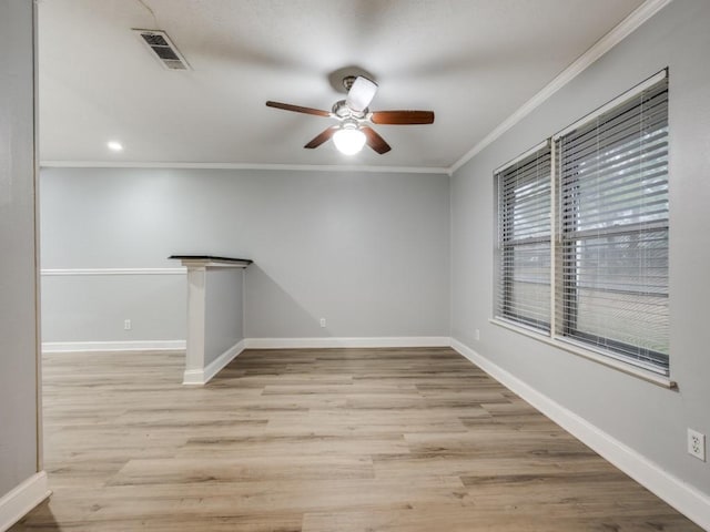 spare room with crown molding, ceiling fan, and light hardwood / wood-style flooring