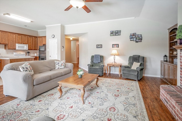 living room with lofted ceiling, hardwood / wood-style floors, ornamental molding, and ceiling fan