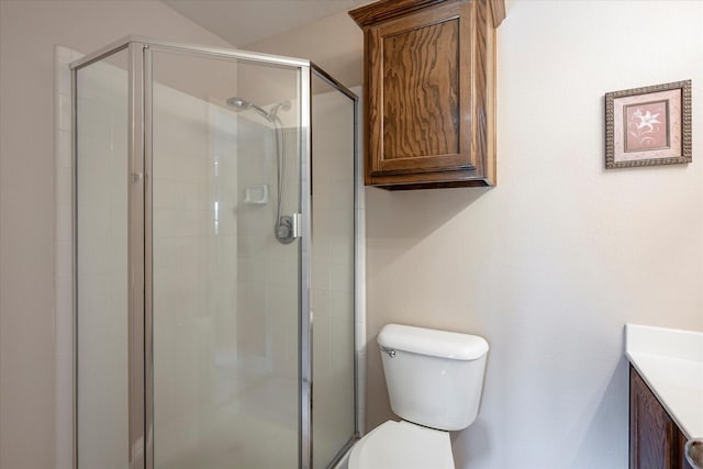 bathroom featuring an enclosed shower, vanity, and toilet