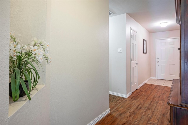 hall with hardwood / wood-style flooring