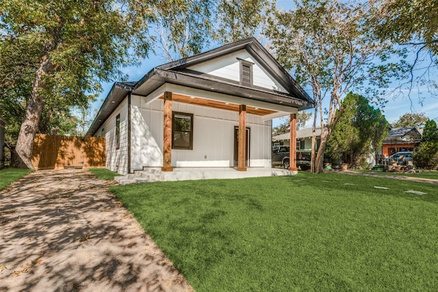 back of house featuring a yard and a patio area