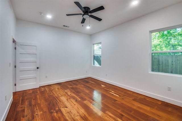 unfurnished room with ceiling fan and dark hardwood / wood-style floors