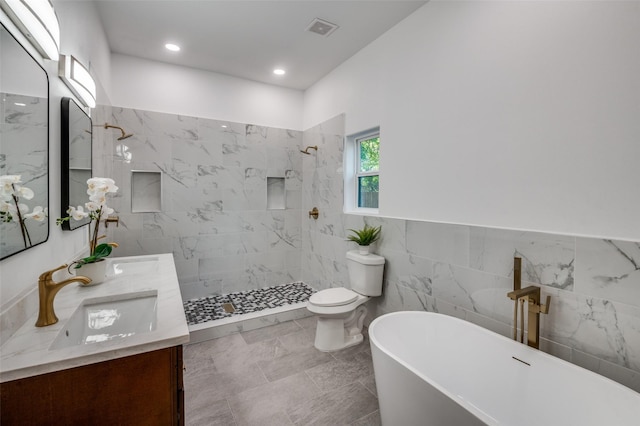 full bathroom with shower with separate bathtub, tile walls, vanity, and toilet