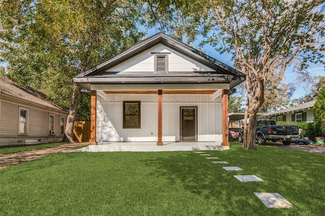 rear view of property featuring a yard