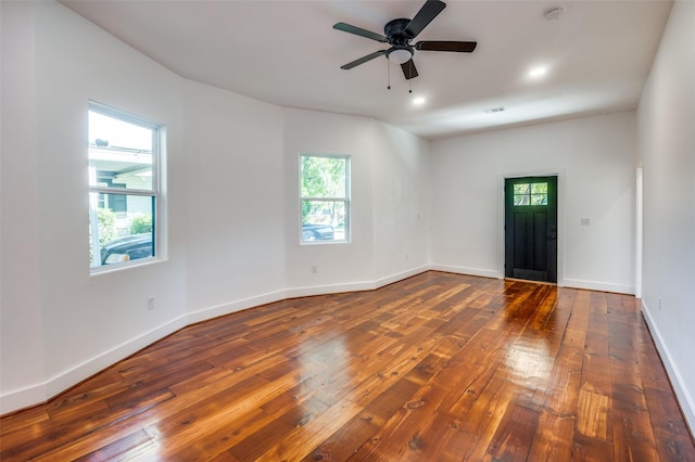 unfurnished room with ceiling fan and dark hardwood / wood-style flooring