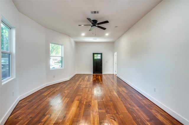 spare room featuring ceiling fan and dark hardwood / wood-style floors