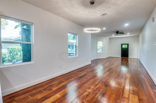 spare room with dark wood-type flooring and ceiling fan