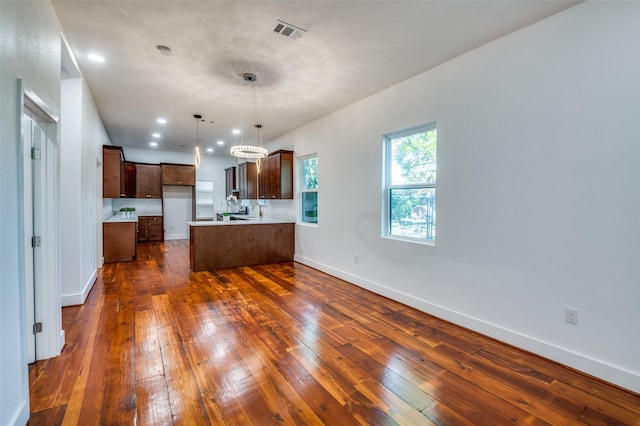 kitchen featuring pendant lighting and dark hardwood / wood-style floors