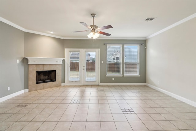 unfurnished living room featuring a tile fireplace, ornamental molding, light tile patterned flooring, and ceiling fan