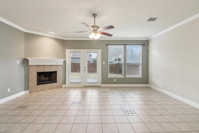 unfurnished living room featuring a tiled fireplace, ornamental molding, light tile patterned floors, and ceiling fan