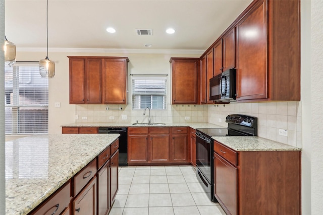 kitchen featuring sink, light stone counters, decorative light fixtures, black appliances, and backsplash