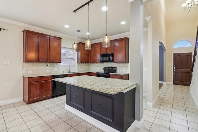 kitchen with light tile patterned flooring, sink, a kitchen island, light stone countertops, and black appliances