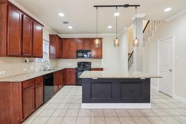 kitchen featuring light stone countertops, decorative light fixtures, black appliances, and a kitchen island