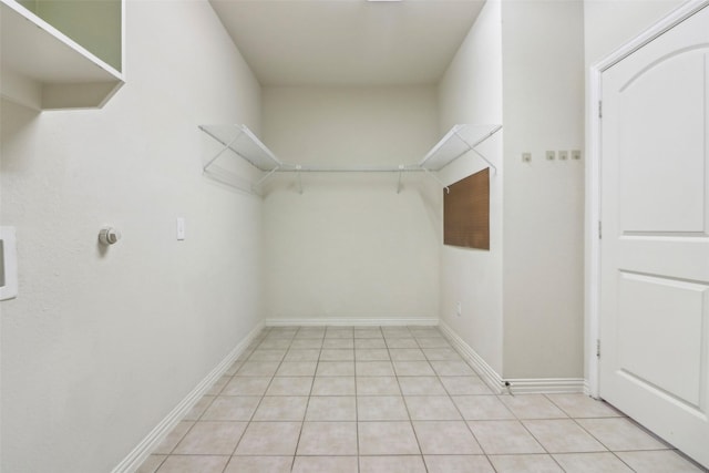 spacious closet with light tile patterned floors