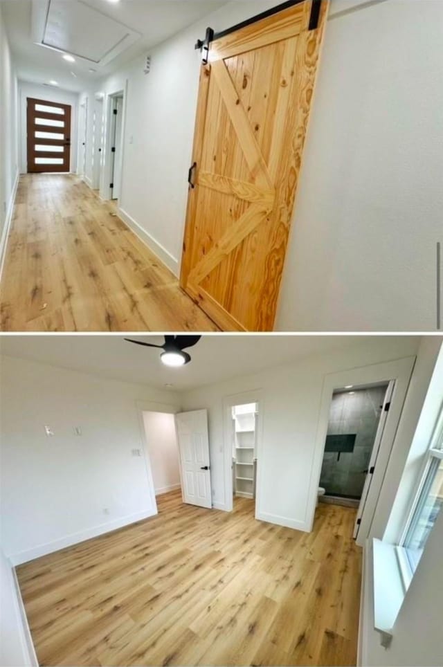 interior space with a barn door, wood finished floors, a towering ceiling, baseboards, and a walk in closet