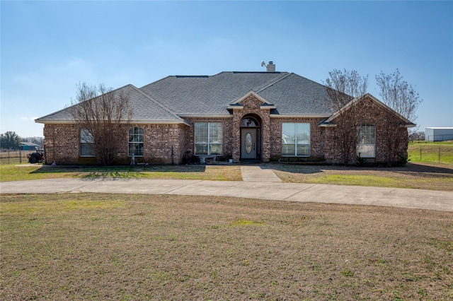 ranch-style home featuring a front yard