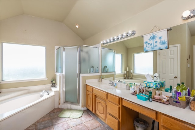 bathroom featuring tile patterned flooring, vanity, lofted ceiling, and independent shower and bath