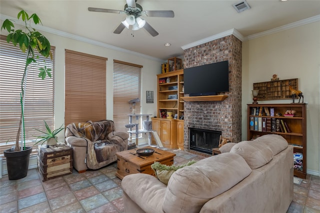 living room featuring crown molding, ceiling fan, a brick fireplace, and a wealth of natural light