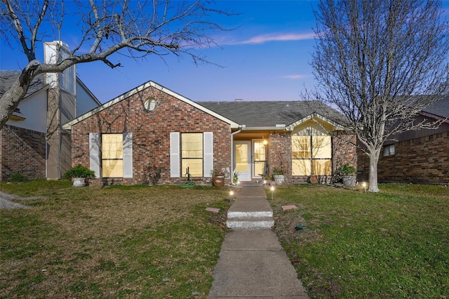 ranch-style home with a lawn