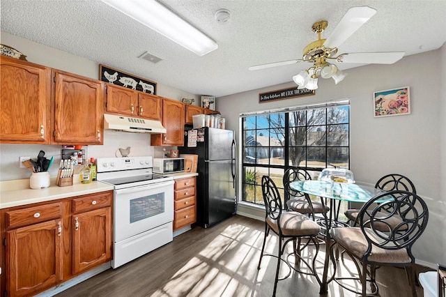 kitchen featuring dark hardwood / wood-style flooring, ceiling fan, white range with electric cooktop, black fridge, and a textured ceiling