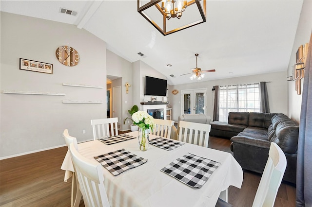 dining room featuring ceiling fan with notable chandelier, high vaulted ceiling, dark wood-type flooring, beam ceiling, and french doors