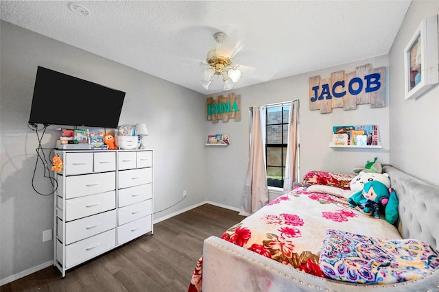 bedroom with dark hardwood / wood-style flooring, ceiling fan, and a textured ceiling