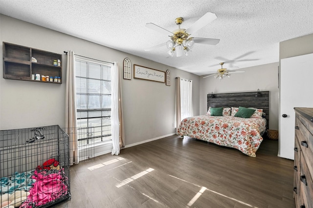 bedroom featuring ceiling fan, a textured ceiling, and dark hardwood / wood-style flooring