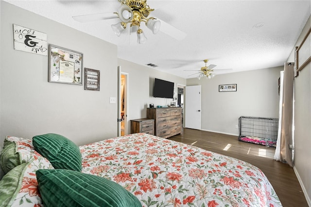 bedroom featuring ceiling fan, dark wood-type flooring, and a textured ceiling